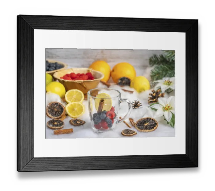 Framed Print : Glass with fresh berries, oranges and lemons in the background Framed Print : Glass with fresh berries, oranges and lemons in the background