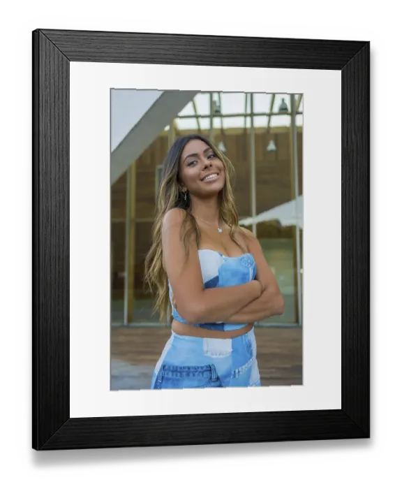 Framed Print : Vertical photo of a pretty woman in denim clothes standing with arm crossed smiling at camera