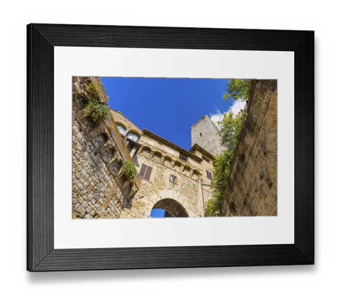 Framed Print : Family tower and medieval buildings against a blue sky