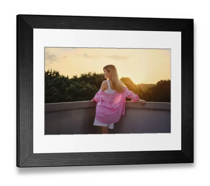 Framed Print : Young woman enjoys the beautiful sunset from her balcony Framed Print : Young woman enjoys the beautiful sunset from her balcony