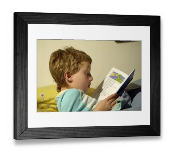 Framed Print : Boy reading in bed