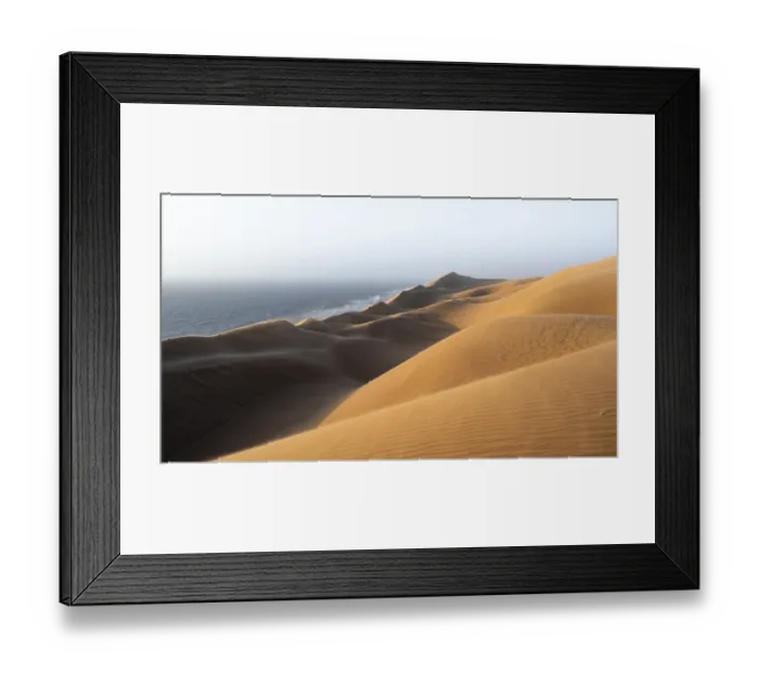 Framed Print : Sand dunes and sea in evening light