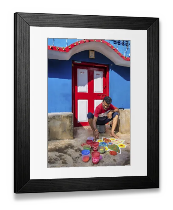Framed Print : Man making a Mandala with colored sand in front of his house