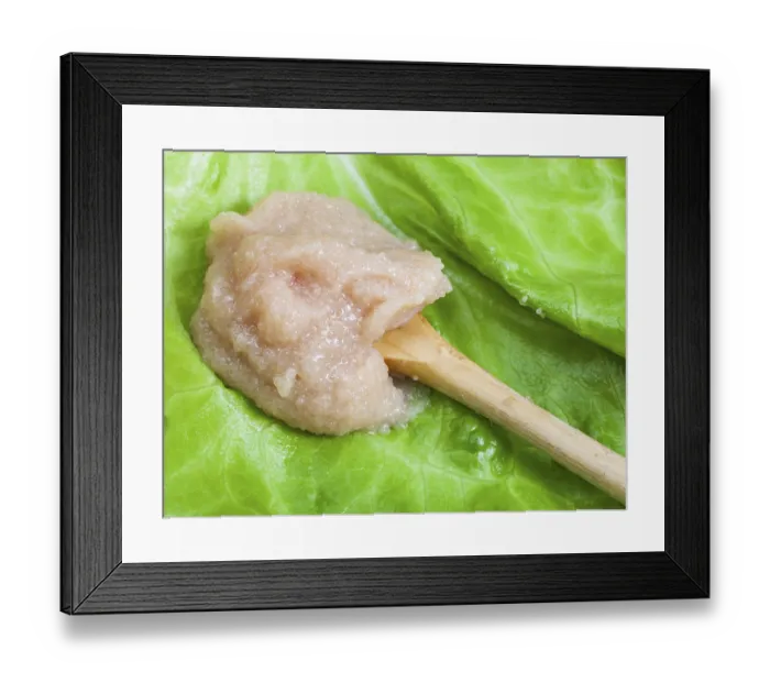 Framed Print : Salty caviar of cod fish on wooden spoon at green leaf