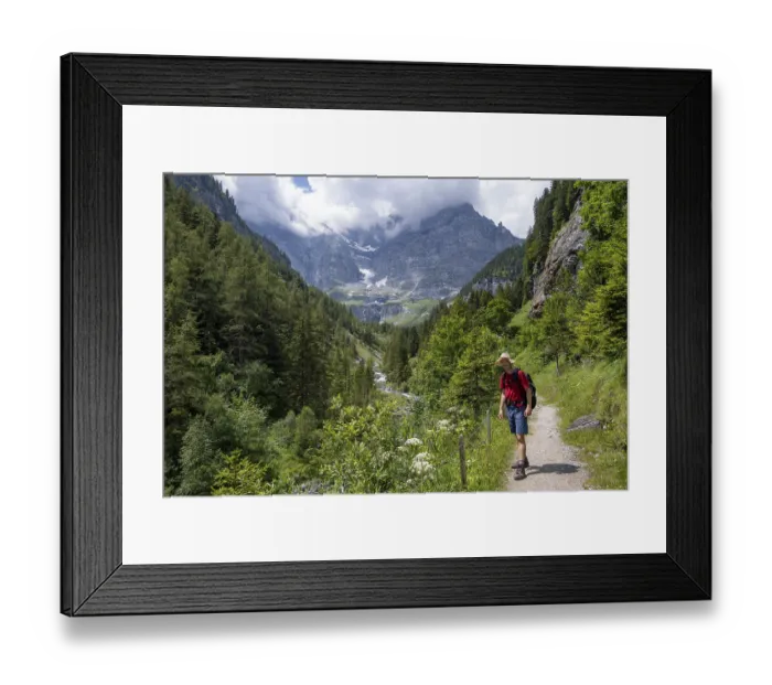 Framed Print : Mountaineers on a hiking trail in the Trachsellauenen Valley with the Weisse Lutschine mountain stream
