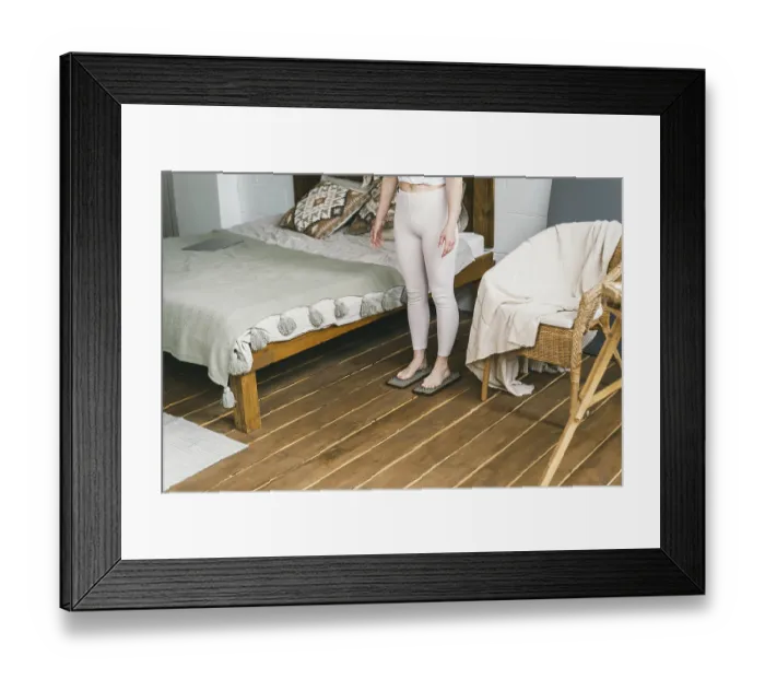 Framed Print : A woman stands on a yoga board with nails Framed Print : A woman stands on a yoga board with nails