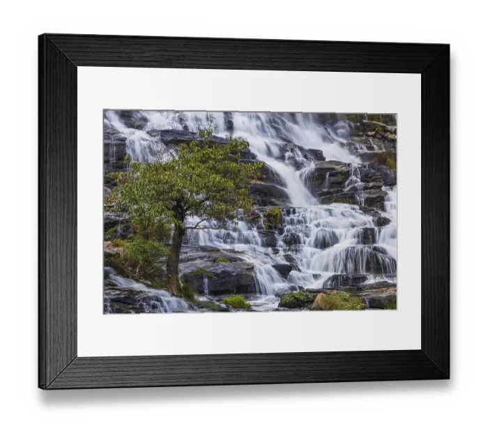 Framed Print : Mae Ya waterfall with cascading flowing water surrounded by lush tropical vegetation