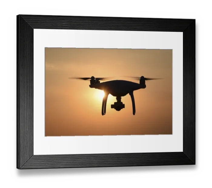 Framed Print : Drone silhouette against the background of the sunset