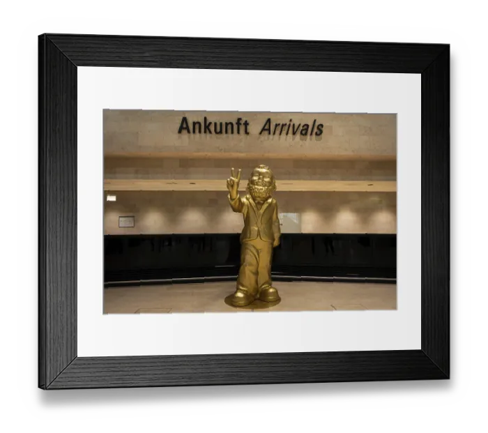 Framed Print : A giant golden garden gnome greets travelers