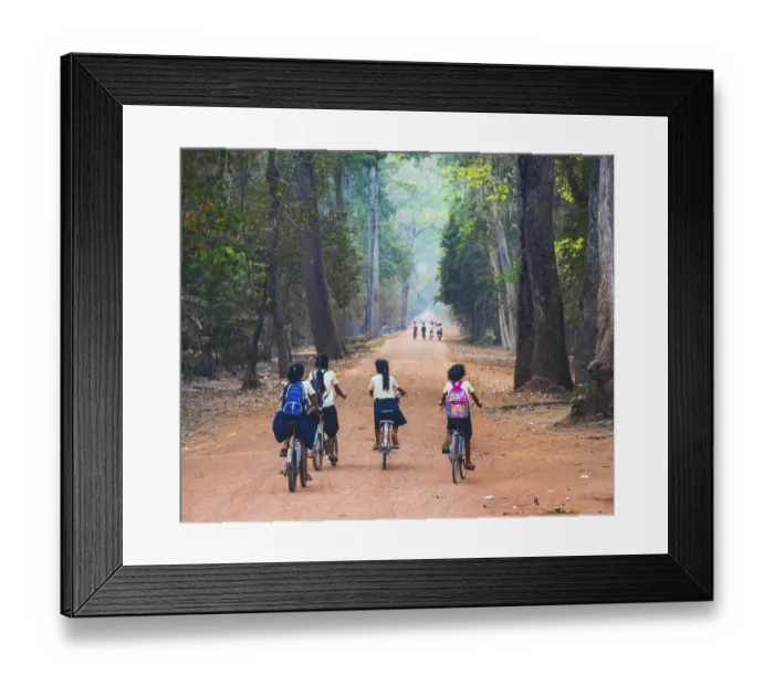 Framed Print : Local children ride bicycles, way to school