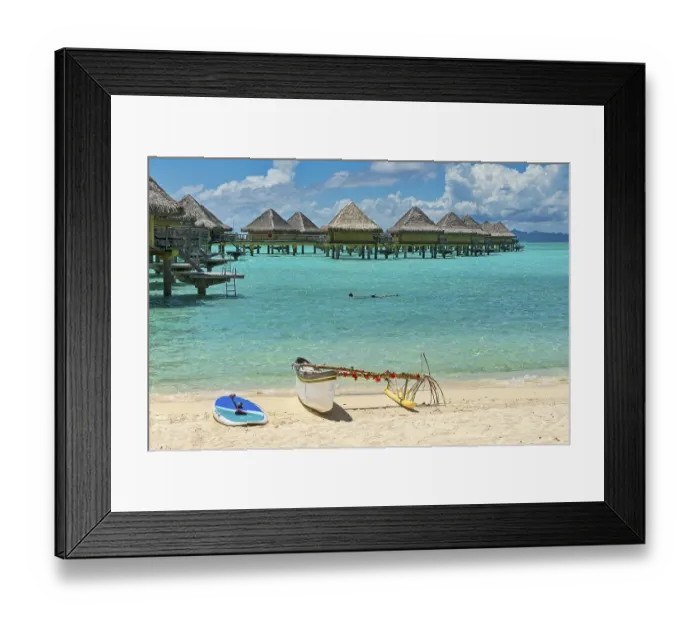 Framed Print : Decorated outrigger boat in front of overwater bungalows