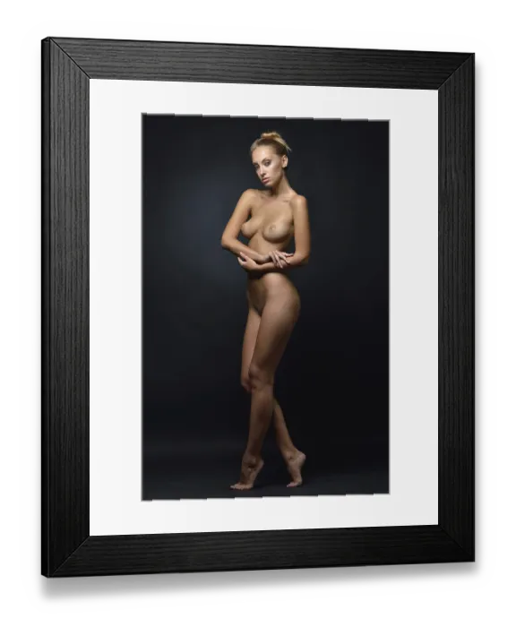 Framed Print : Beautiful tanned naked blonde woman posing in a dark Studio