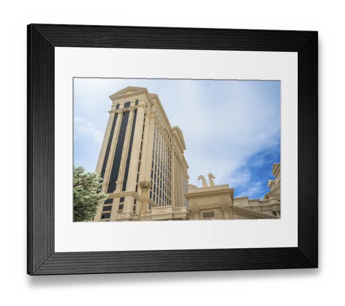 Framed Print : Tall building showcasing classic roman architectural design with columns and horse statues under a bright blue sky