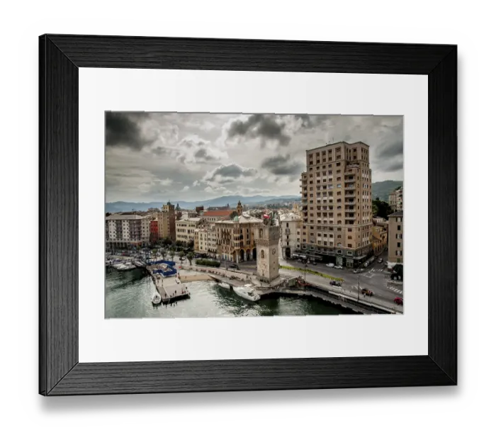 Framed Print : An old clock tower stand by the harbour in front of the town called Savona Framed Print : An old clock tower stand by the harbour in front of the town called Savona