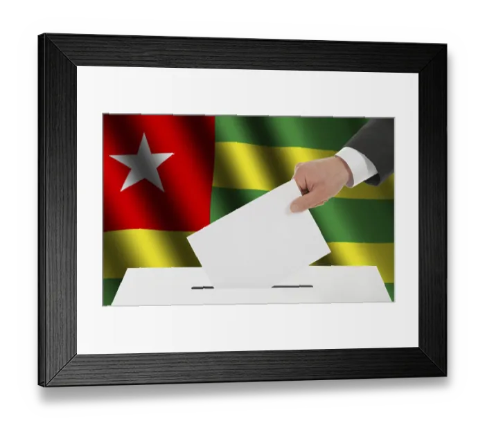 Framed Print : The Togo flag and the hand with the bulletin about the ballot box Framed Print : The Togo flag and the hand with the bulletin about the ballot box