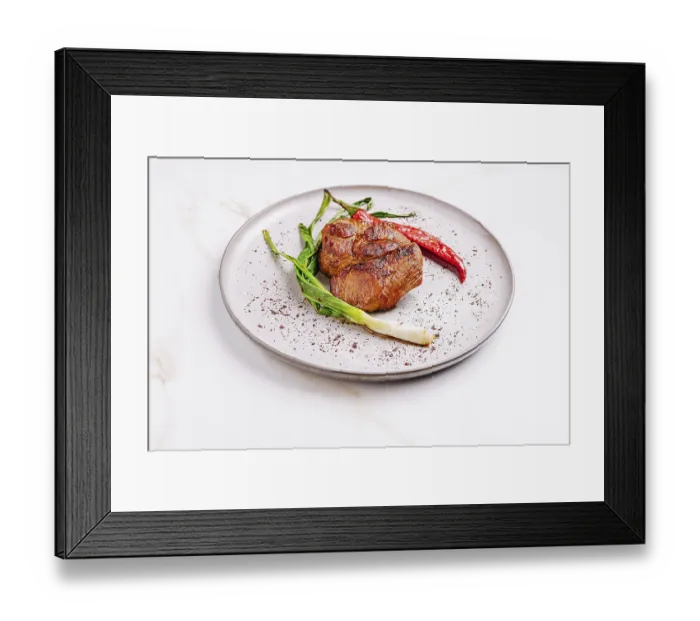Framed Print : Succulent grilled meat sits on a textured plate surrounded by fresh scallions and bright red chili peppers