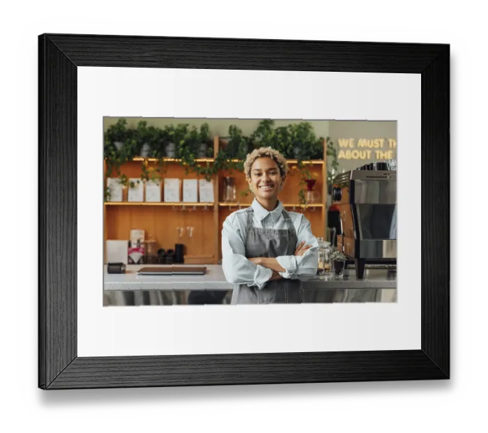 Framed Print : Smiling confident coffee shop owner at the counter