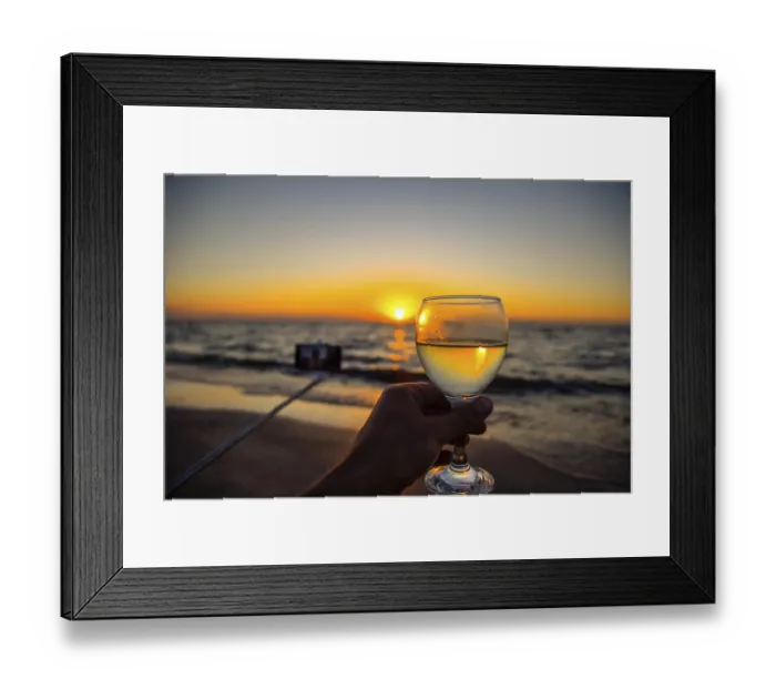 Framed Print : Selfie with a selfie stick on the beach at sunset with a glass of champagne