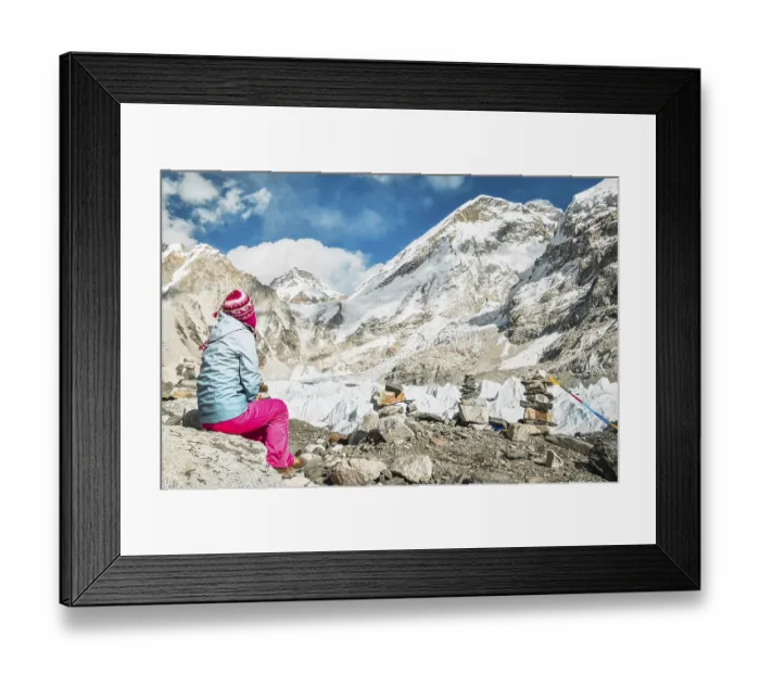 Framed Print : Woman trekker alone sit on rock by EBC viewpoint enjoy Sagarmatha national park with mountains background
