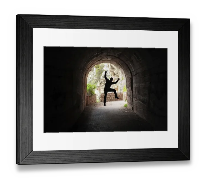Framed Print : Silhouette of a man jumping in a dark tunnel on the walking path in Petrovac bay Framed Print : Silhouette of a man jumping in a dark tunnel on the walking path in Petrovac bay