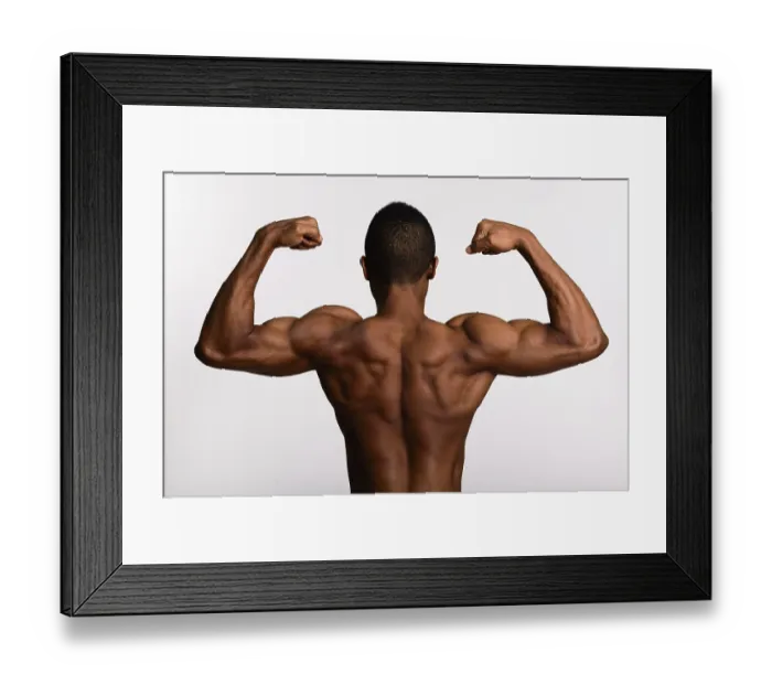 Framed Print : Young muscular African man shirtless flexing both arms isolated against white background