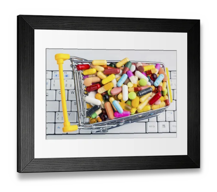 Framed Print : Tablets with shopping trolley. Symbolic photo for the purchase of medicines on the Internet Austria
