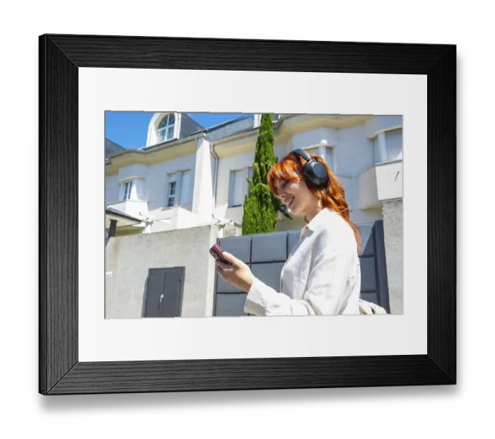 Framed Print : Young woman with red hair wearing headphones and a white shirt