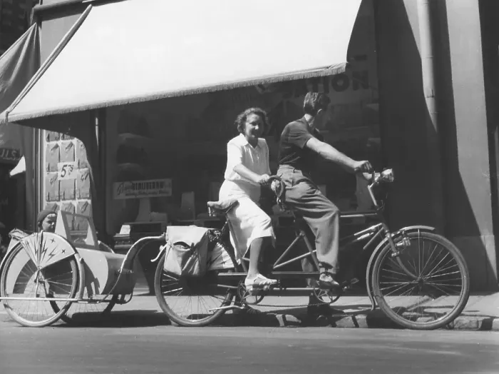 Framed Print : 1940s couple on a tandem bicycle. The young couple have their son in a bicycle carriage behind their bicycle. Sweden 1940s