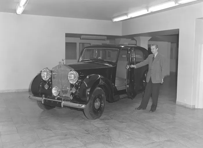 Framed Print : In the 1940s. A man has opened the front door of a brand new Rolls Royce car Framed Print : In the 1940s. A man has opened the front door of a brand new Rolls Royce car