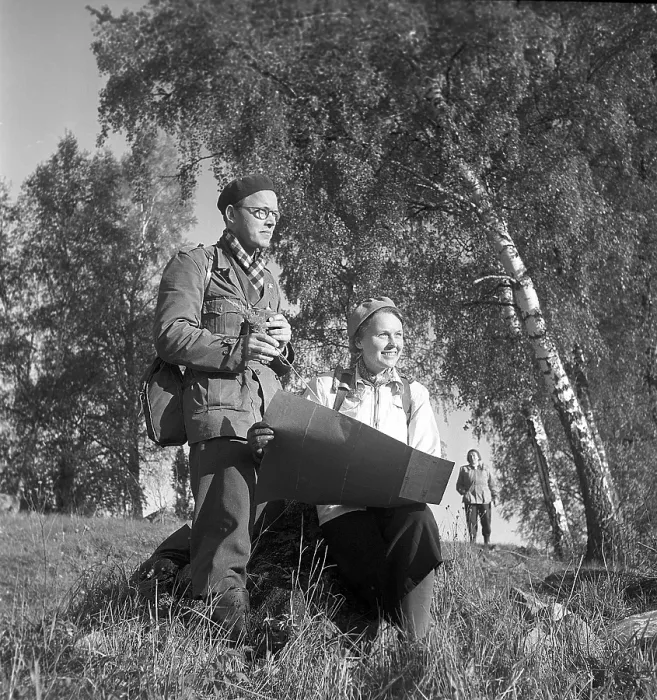 Framed Print : 1940s outdoor life. A couple is out in the nature and is interested in plants and flowers Framed Print : 1940s outdoor life. A couple is out in the nature and is interested in plants and flowers