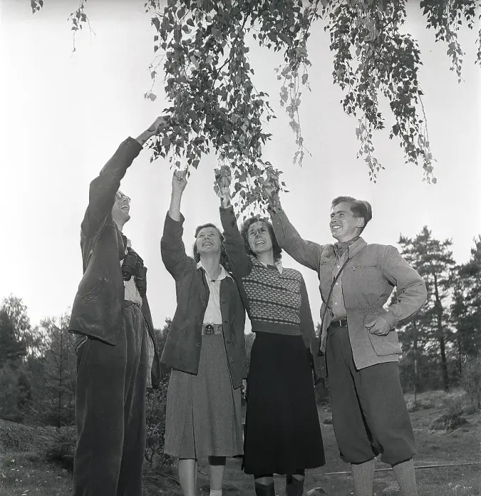 Framed Print : 1940s outdoor life. A group of young people are out in the nature and is interested in plants and flowers. They are wearing the typical 1940s kind of outdoor clothes of sport character that is practical and durable
