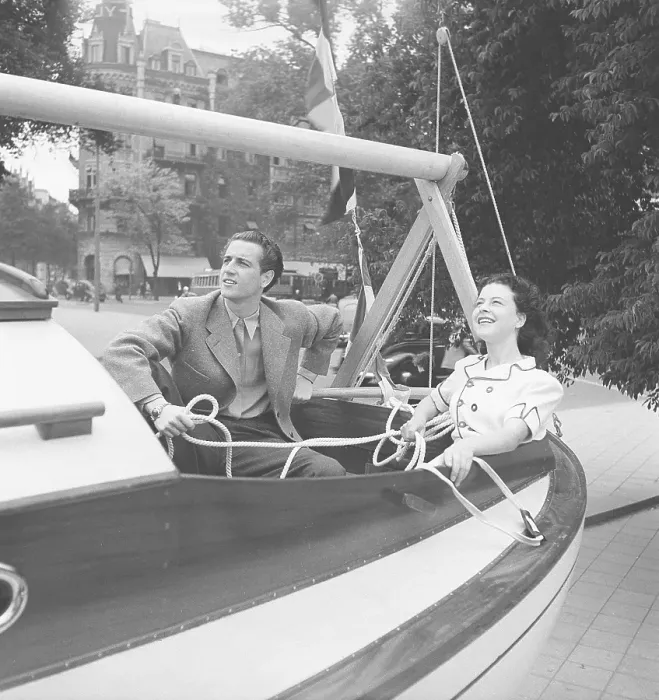 Framed Print : 1940s summer. A young couple in a sailingboat on dry land Framed Print : 1940s summer. A young couple in a sailingboat on dry land