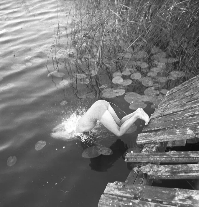 Framed Print : 1940s summer. A young girl is pictured in the moment when she dives into the water Framed Print : 1940s summer. A young girl is pictured in the moment when she dives into the water