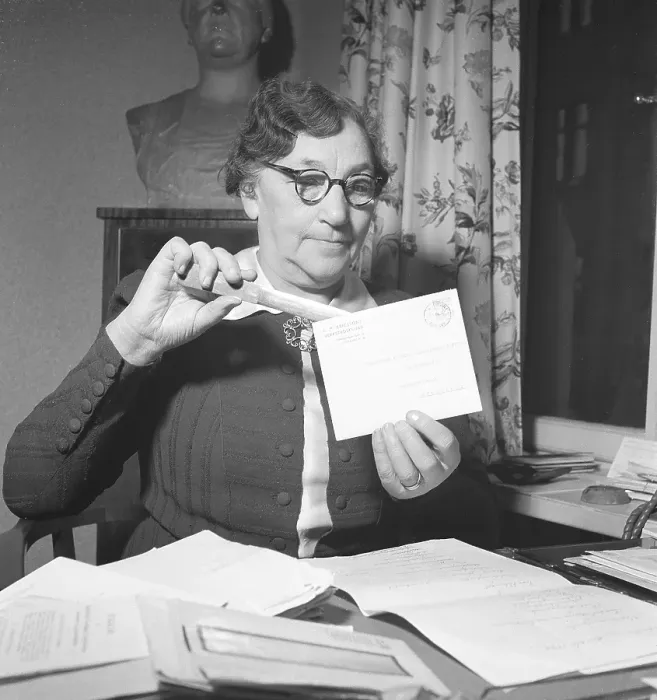 Framed Print : 1940s woman with glasses. An older lady is opening an envelope with a letter knife Framed Print : 1940s woman with glasses. An older lady is opening an envelope with a letter knife