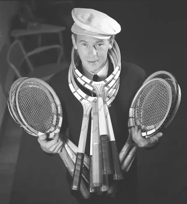 Framed Print : In the 1940s. A young man in a cap stands and holds the tennis racket in his hands Framed Print : In the 1940s. A young man in a cap stands and holds the tennis racket in his hands