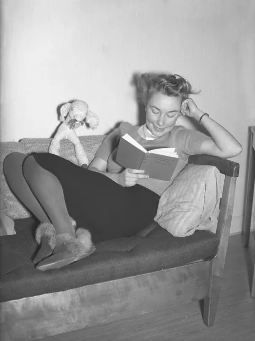 Framed Print : In the 1940s. A young woman at home reading from a book while sitting comfortable in a sofa. February 1940 Kristoffersson ref 53-5