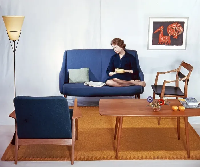 Framed Print : In the 1950s 1960s. A woman is sitting comfortably in a couch reading the newspaper and having a cup of tea Framed Print : In the 1950s 1960s. A woman is sitting comfortably in a couch reading the newspaper and having a cup of tea