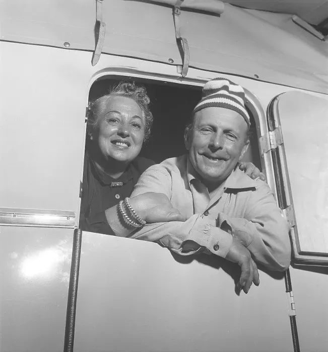 Framed Print : 1950s camping. A couple in their caravan looking through the door Framed Print : 1950s camping. A couple in their caravan looking through the door