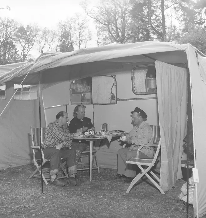 Framed Print : 1950s camping. Three people are sitting by their caravan enjoying a cup of coffee