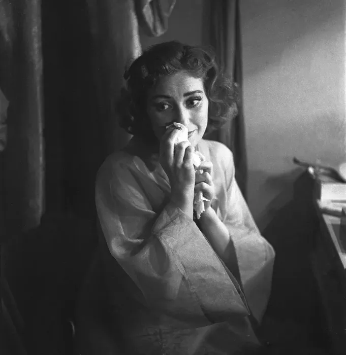 Framed Print : In the 1950s. A dark-haired woman sits and looks sad
