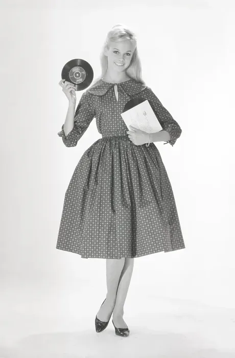 Framed Print : 1950s fashion. A young woman in a typical 1950s dress