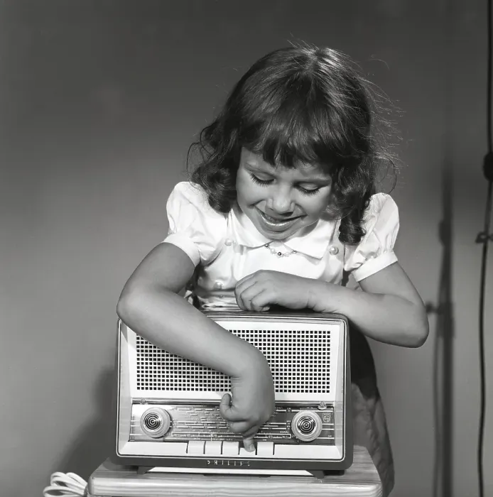 Framed Print : In the 1950s. A girl with a Philips radio set