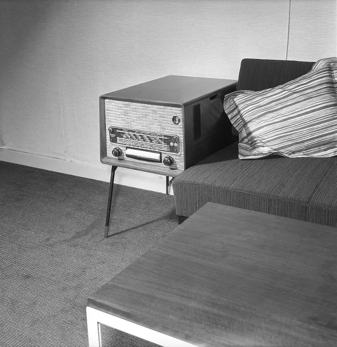 Framed Print : In the 1950s. Interior of a living room with a Philips radio standing on the small table on the side of the sofa