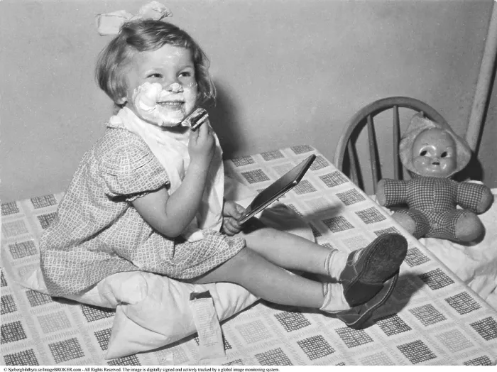 Framed Print : In the 1950s, a little girl with soap on her chin is captured in a playful moment Framed Print : In the 1950s, a little girl with soap on her chin is captured in a playful moment