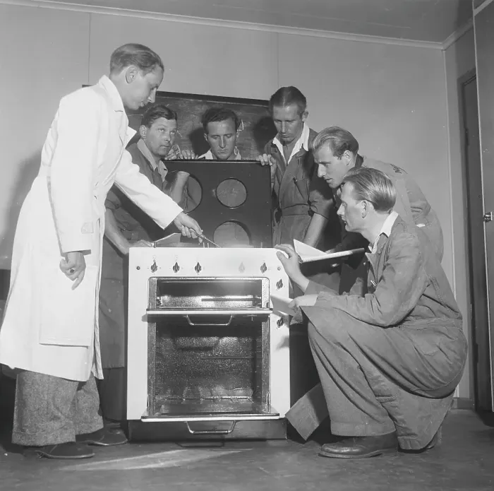 Framed Print : In the 1950s. A man at an electric cooker from swedish manufacturer Husqvarna