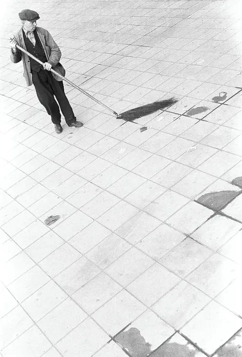 Framed Print : In the 1950s. A man is working outdoors sweeping the rubbish and trash from the street Framed Print : In the 1950s. A man is working outdoors sweeping the rubbish and trash from the street