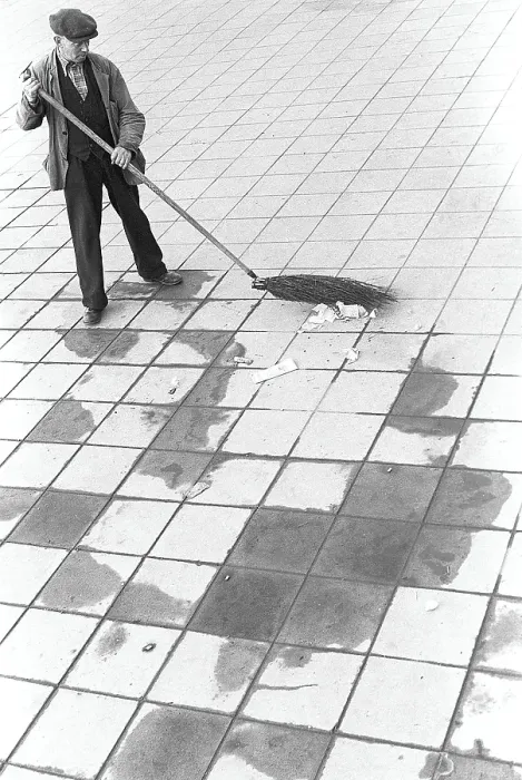 Framed Print : In the 1950s. A man is working outdoors sweeping the rubbish and trash from the street. Sweden 1953. ref 2A-25