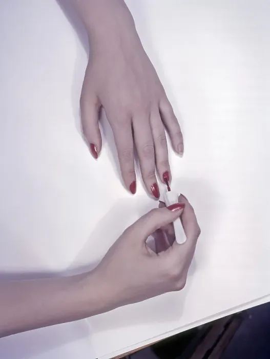 Framed Print : 1950s nails. A woman is painting her nails red. Sweden 1950s