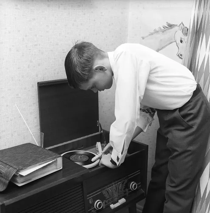 Framed Print : In the 1950s. A teenage boy has put on a gramophone record