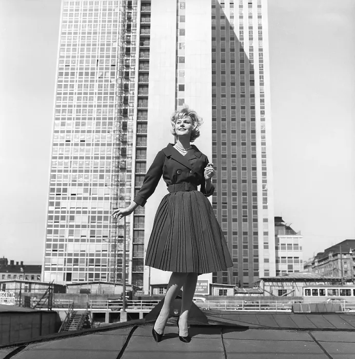 Framed Print : In the 1950s. A woman modelling a 1950s outfit with a jacket and skirt in matching dark Framed Print : In the 1950s. A woman modelling a 1950s outfit with a jacket and skirt in matching dark